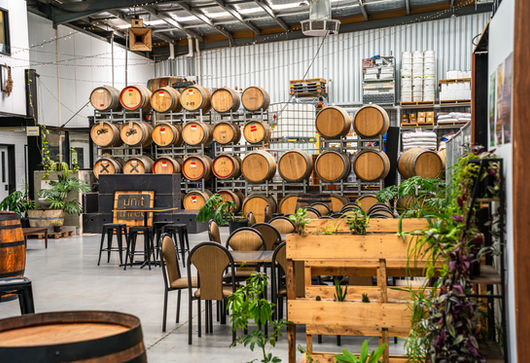 Unit Three Collective event space — exposed brick, timber beams, catering spread